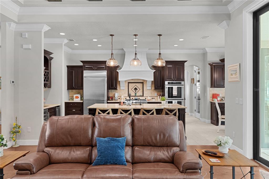 10994 North River Ranch Path Crystal River, FL 34428 - Photo 12 of 58 a living room with furniture kitchen view and a chandelier