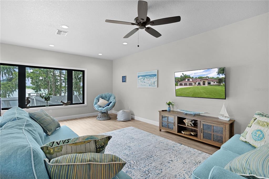 10994 North River Ranch Path Crystal River, FL 34428 - Photo 29 of 58 a living room with furniture a flat screen tv and a fireplace