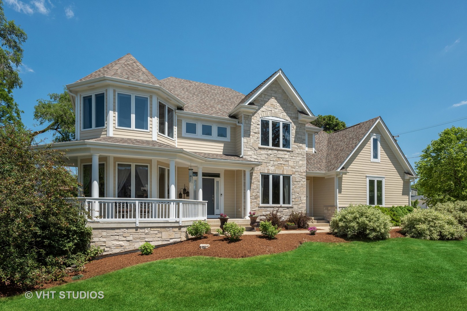 a front view of a house with a yard and porch