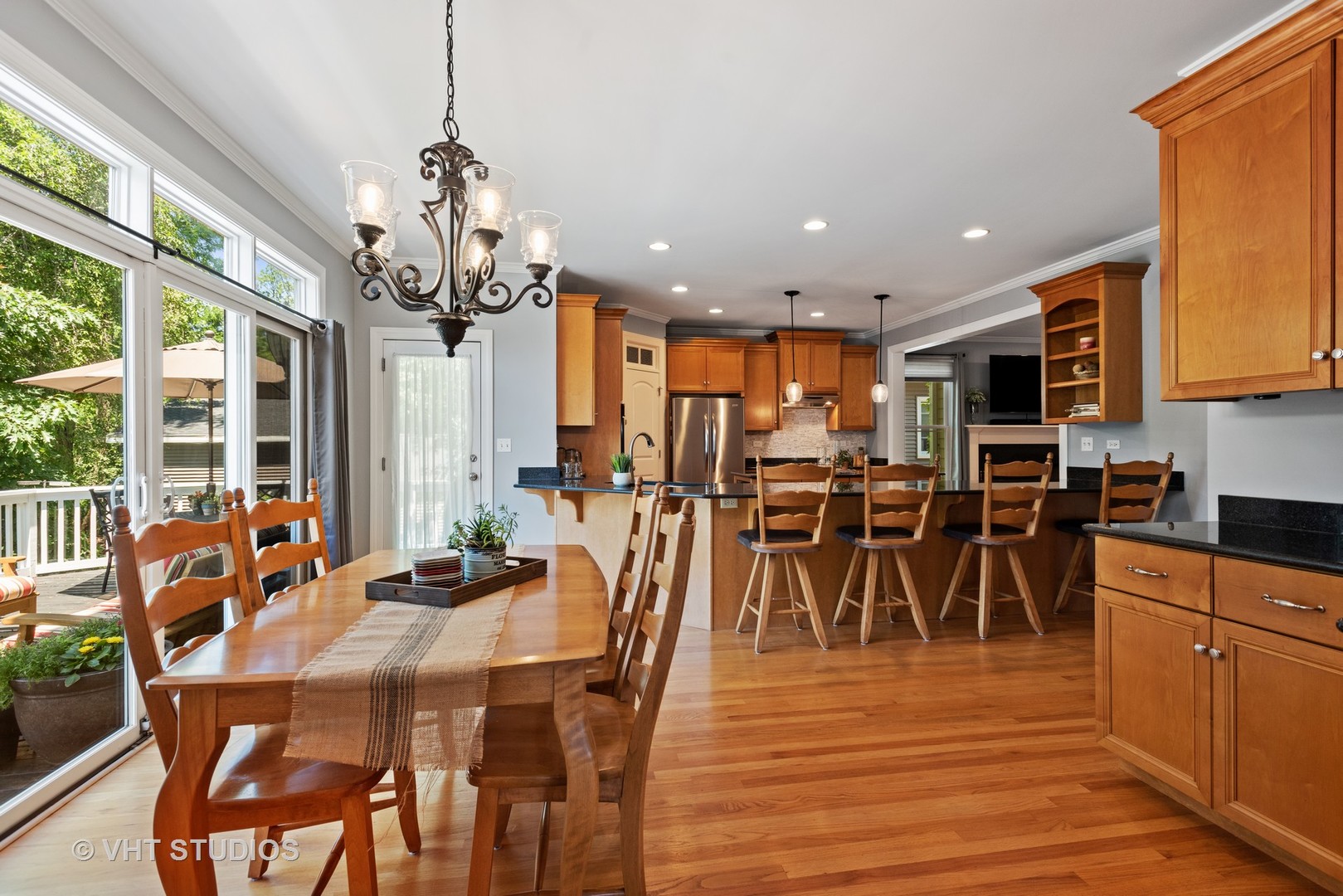N210 Silverleaf Boulevard Wheaton, IL 60187 - Photo 13 of 48 a view of a dining room with furniture a chandelier and wooden floor