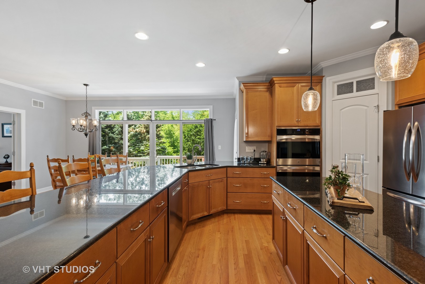 N210 Silverleaf Boulevard Wheaton, IL 60187 - Photo 15 of 48 a kitchen with stainless steel appliances granite countertop sink stove refrigerator dining table and chairs