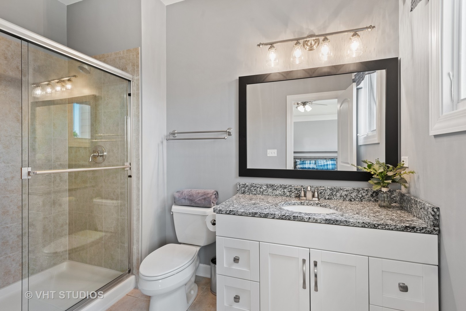 N210 Silverleaf Boulevard Wheaton, IL 60187 - Photo 32 of 48 a bathroom with a granite countertop sink a toilet and a mirror