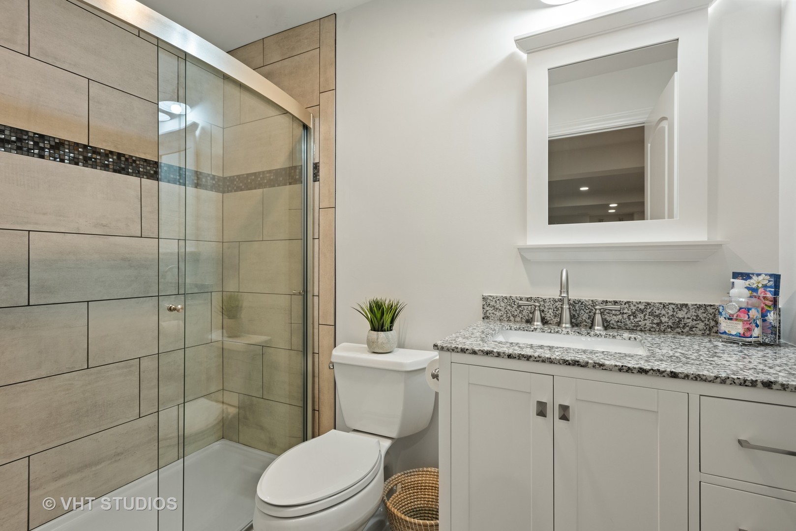 N210 Silverleaf Boulevard Wheaton, IL 60187 - Photo 38 of 48 a bathroom with a granite countertop sink mirror a toilet and a shower