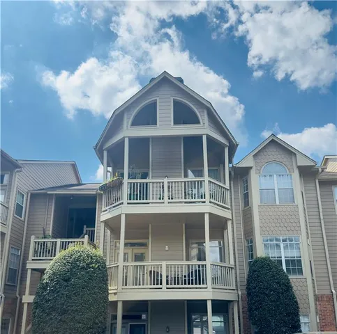 a view of a brick house with large windows