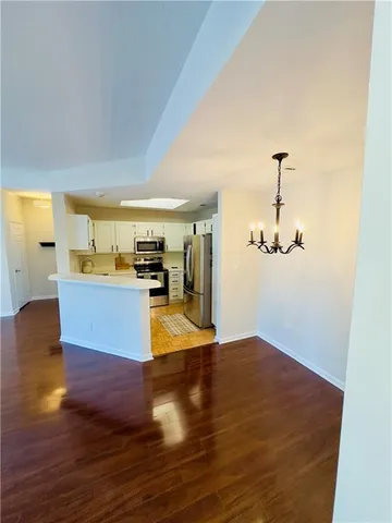 a view of a living room and kitchen with furniture