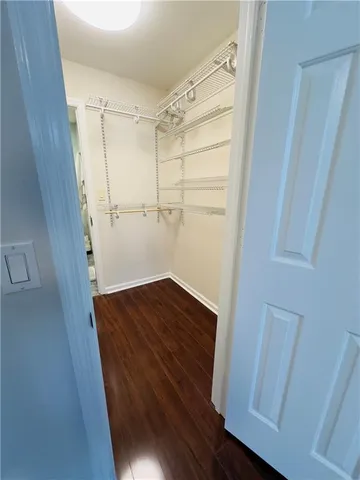 a view of storage and utility room with wooden floor