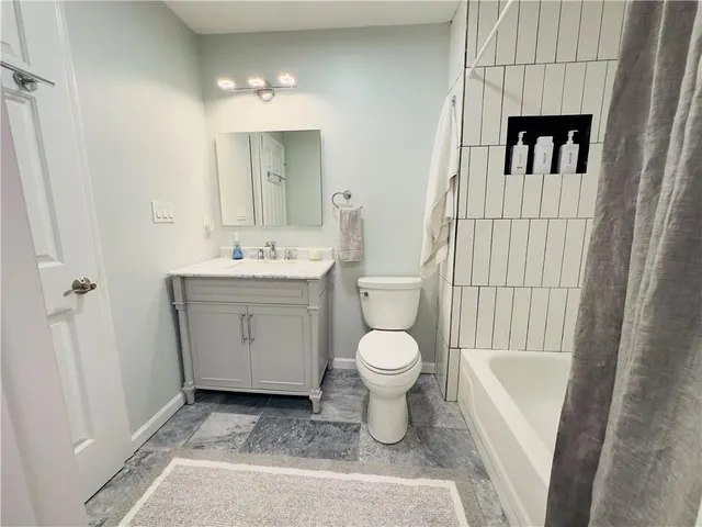 a bathroom with a sink toilet and vanity