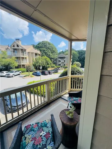 a balcony with furniture and wooden floor