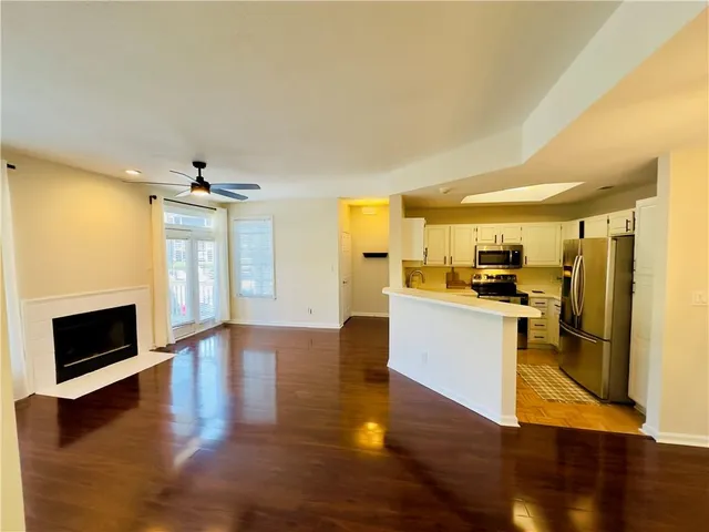 a view of open kitchen with wooden floor and electronic appliances