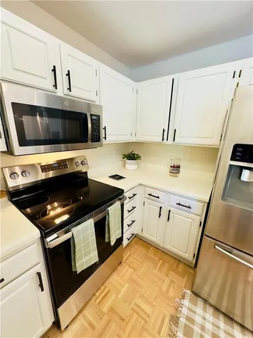 a kitchen with a stove microwave and sink