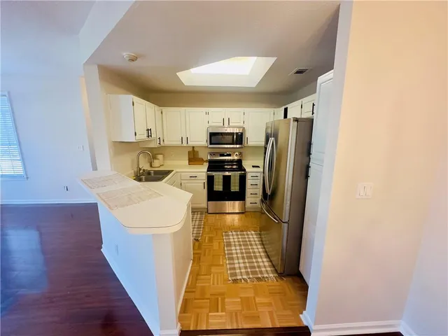 a kitchen with stainless steel appliances a refrigerator and a stove top oven