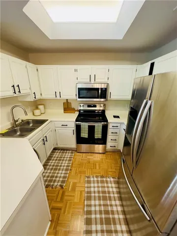 a kitchen with a sink a stove and refrigerator