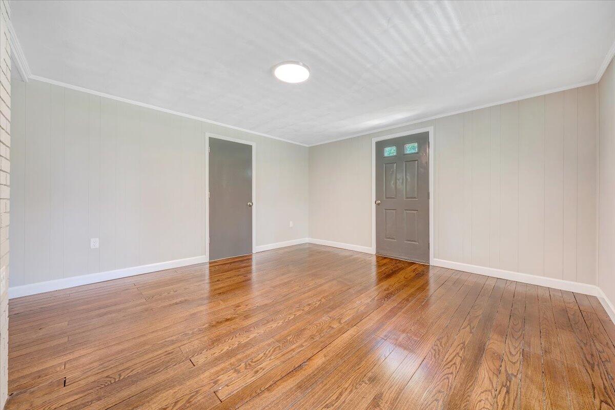 350 Mills Road Callaway, VA 24067 - Photo 2 of 45 an empty room with wooden floor and windows
