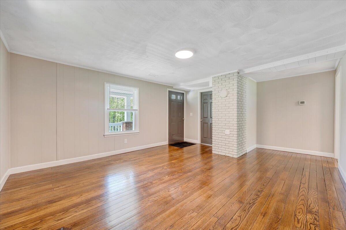 350 Mills Road Callaway, VA 24067 - Photo 4 of 45 a view of an empty room with wooden floor and a window