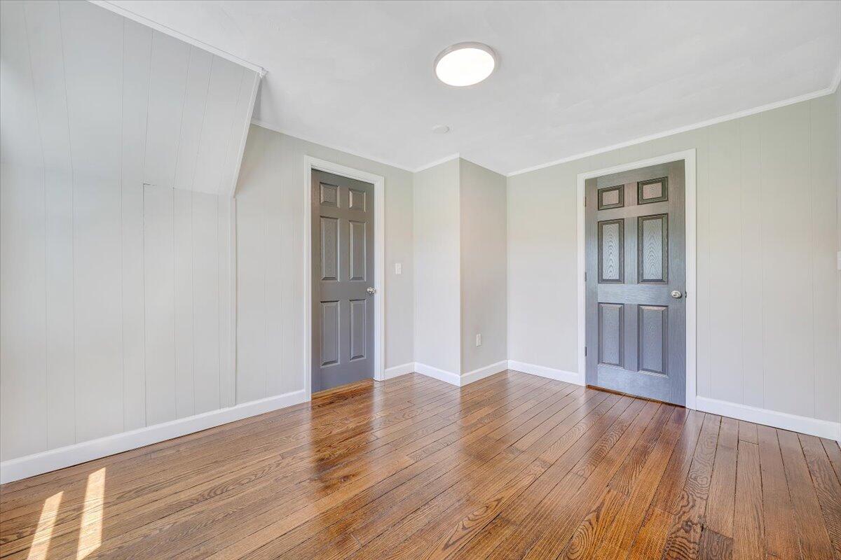 350 Mills Road Callaway, VA 24067 - Photo 6 of 45 an empty room with wooden floor and windows