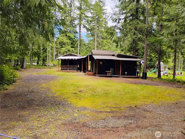 a backyard of a house with barbeque oven table and chairs
