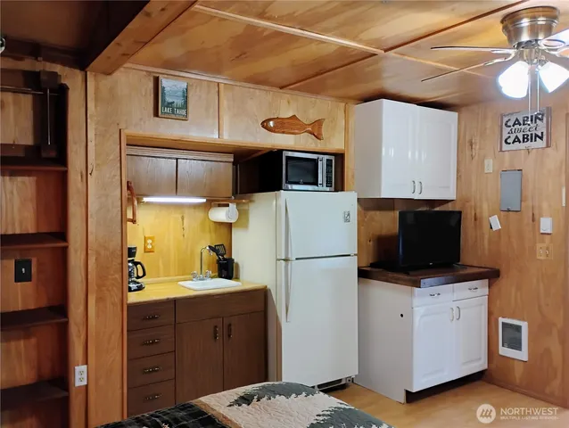 a kitchen with a refrigerator and a stove