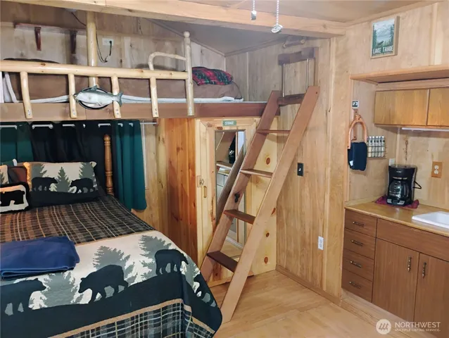 a view of a bedroom with furniture and a window