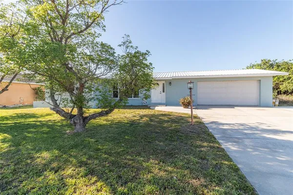 a backyard of a house with table and chairs