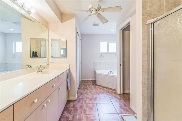 a spacious bathroom with a double vanity sink a mirror and a bathtub