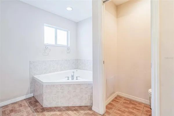 a bathroom with a tub and window