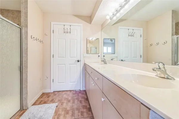 a spacious bathroom with a bathtub sink and mirror