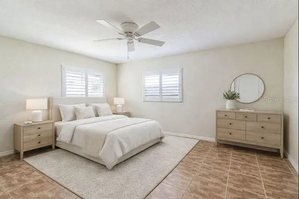 a bedroom with a large bed and a dresser