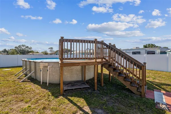 a view of a balcony with wooden floor and iron fence