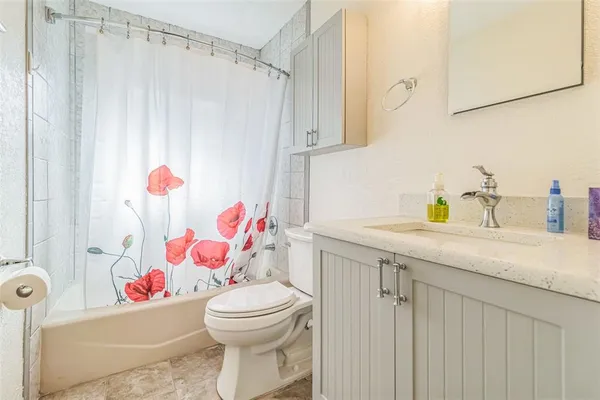 a bathroom with a sink toilet vanity and shower