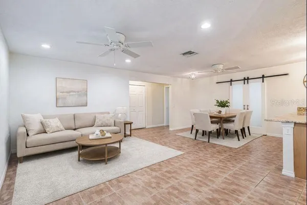 a living room with furniture and a chandelier