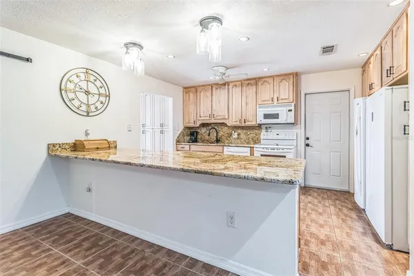 a kitchen with stainless steel appliances granite countertop a sink and a stove