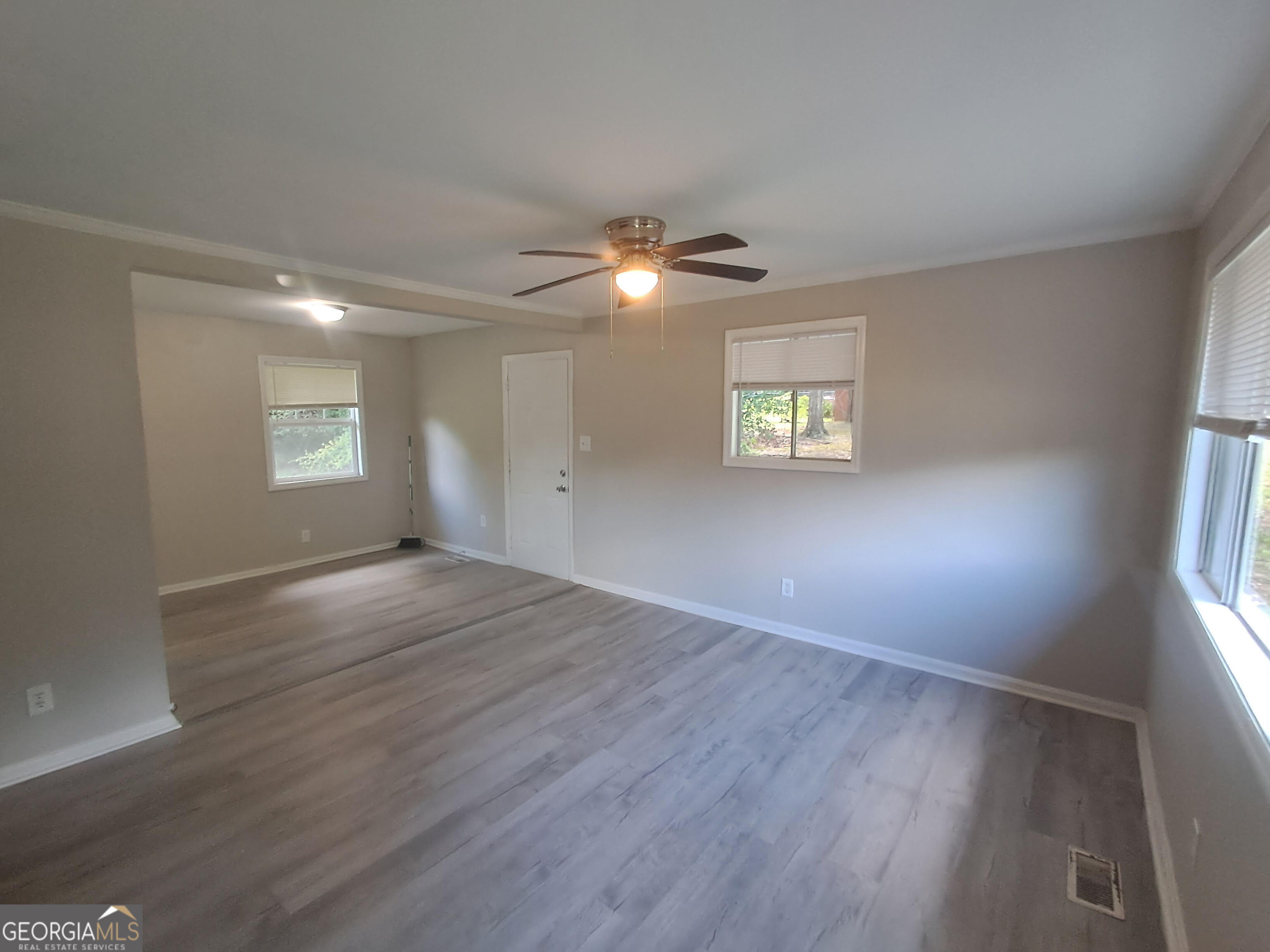 193 Frazier Drive Southeast Milledgeville, GA 31061 - Photo 12 of 38 a view of an empty room with a window and wooden floor