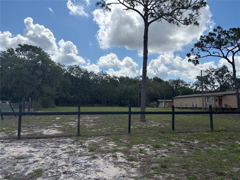 15546 Hicks Road Hudson, FL 34667 - Photo 4 of 8 a backyard of a house with lots of green space