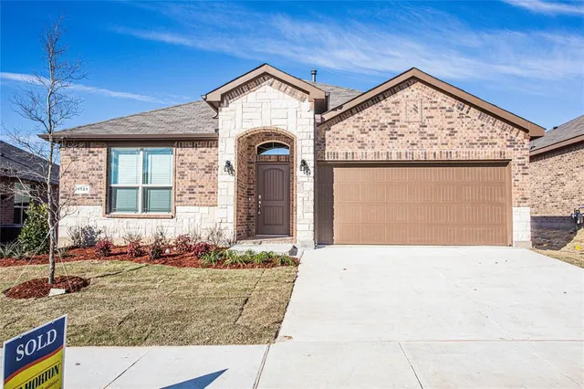 a front view of a house with lots of windows