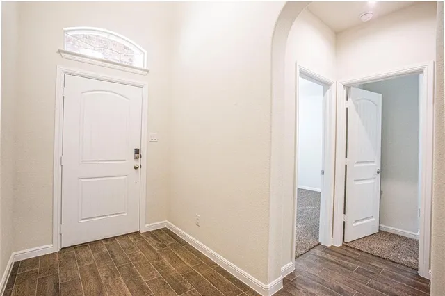 a view of hallway with wooden floor