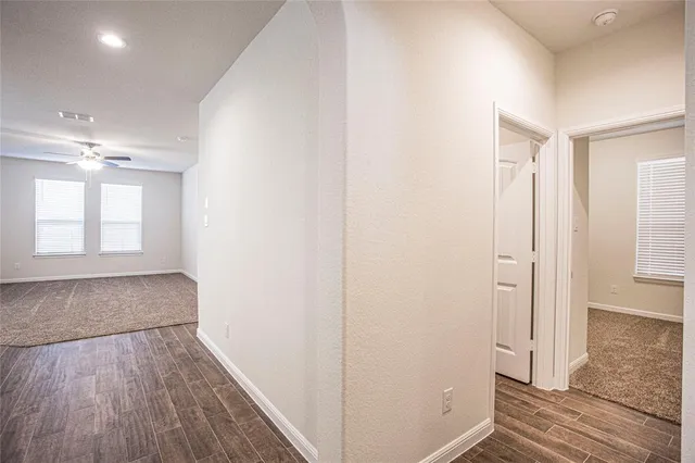 a view of hallway with wooden floor