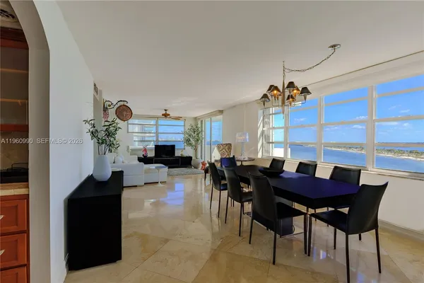 a view of a dining room with furniture and chandelier