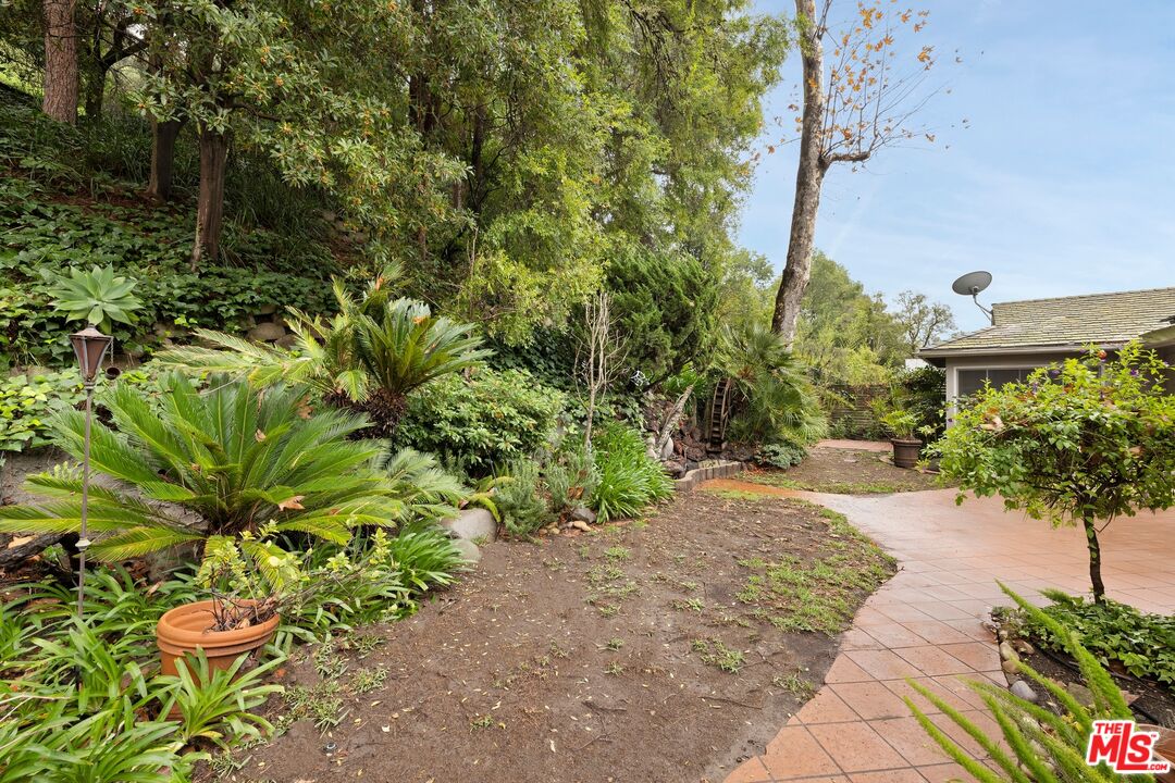 1444 Roscomare Road Los Angeles, CA 90077 - Photo 15 of 19 a view of a garden with plants