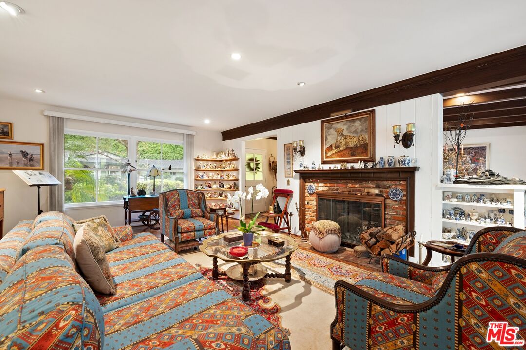 1444 Roscomare Road Los Angeles, CA 90077 - Photo 2 of 19 a living room with furniture fireplace and a large window