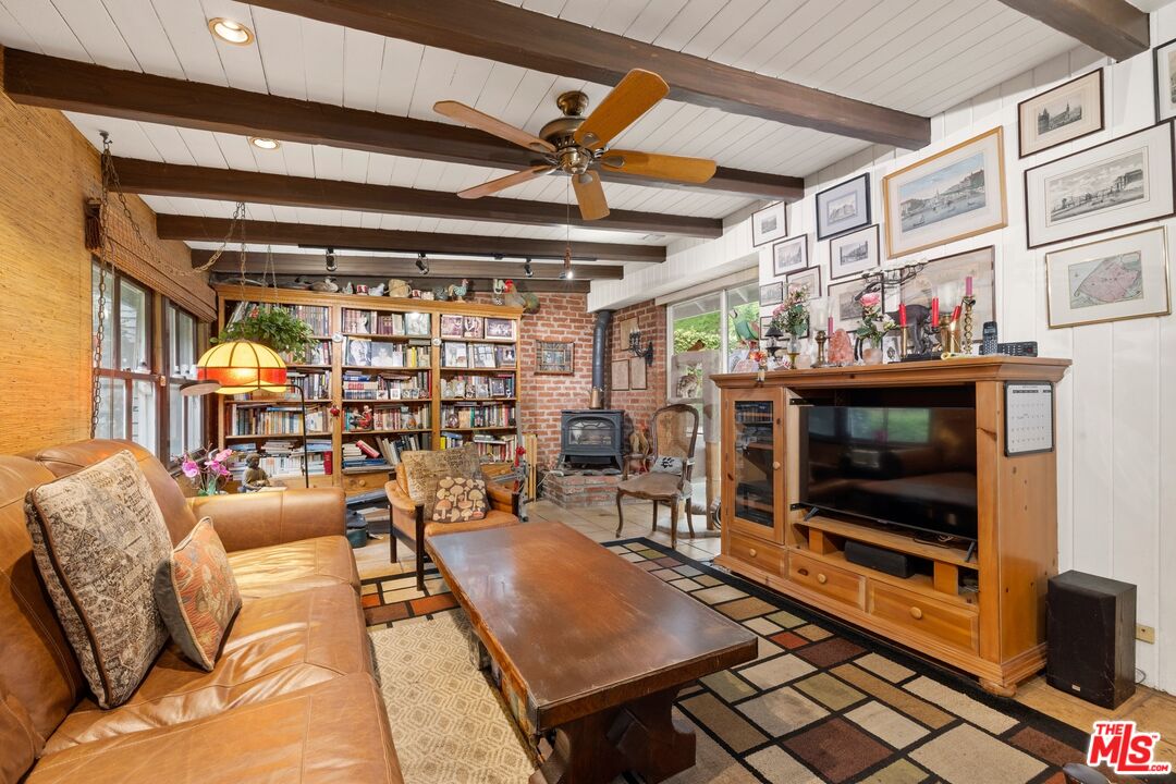 1444 Roscomare Road Los Angeles, CA 90077 - Photo 8 of 19 a living room with furniture a flat screen tv and a floor to ceiling window