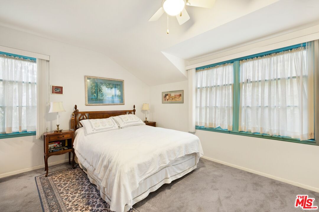 1444 Roscomare Road Los Angeles, CA 90077 - Photo 9 of 19 a bedroom with a large bed and a large window