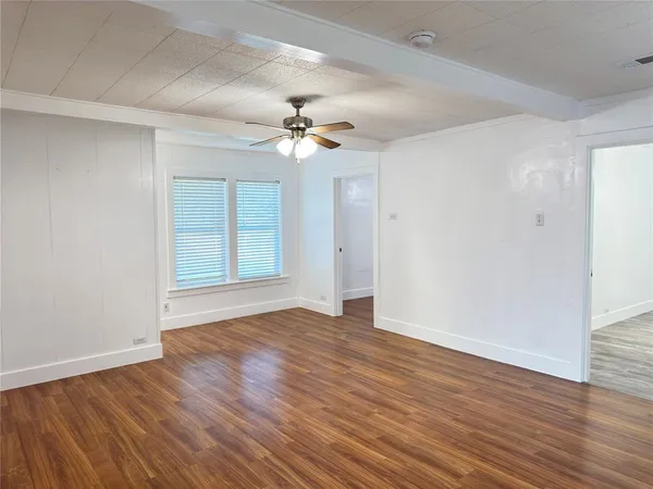 wooden floor in an empty room with a window