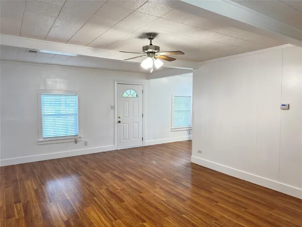 wooden floor in an empty room with a window
