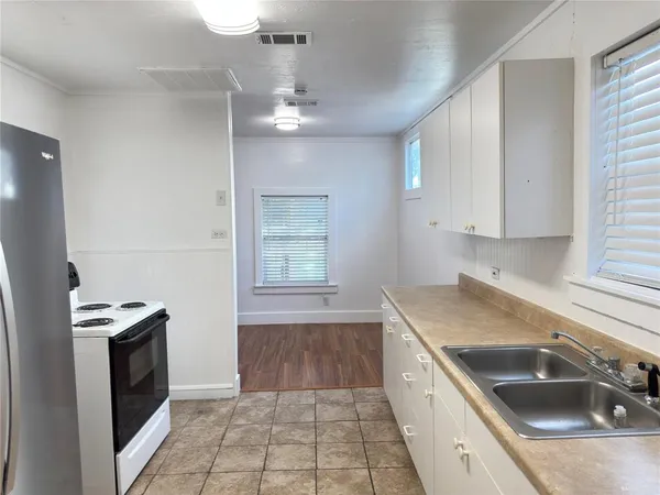 a kitchen that has a sink and a stove