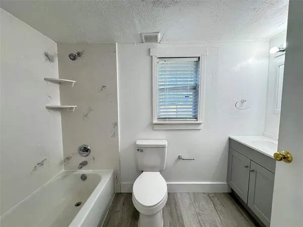 a bathroom with a bathtub toilet and sink