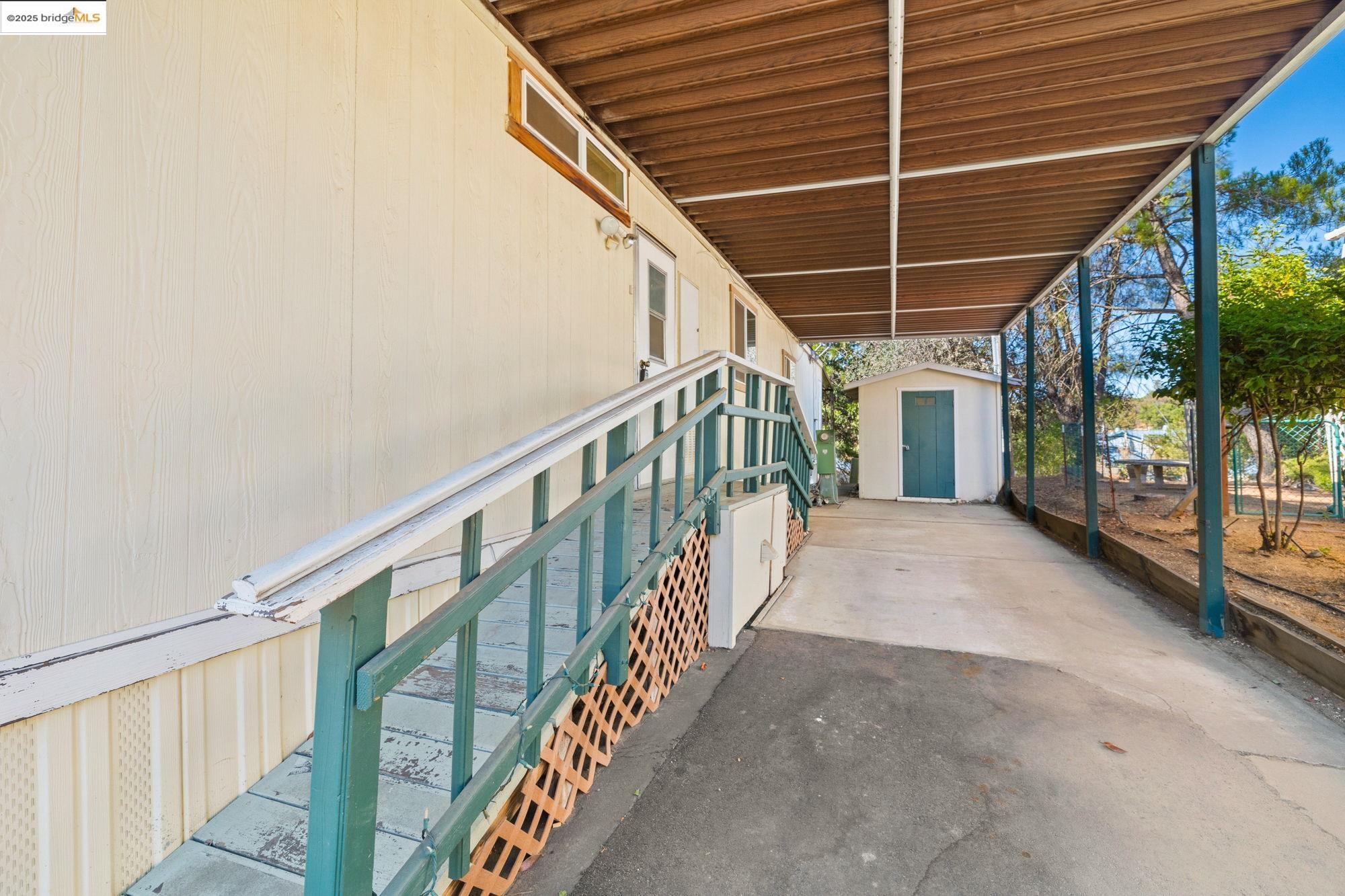 10956 Green Street, Unit 186 Columbia, CA 95310 - Photo 20 of 21 View of patio with a storage shed
