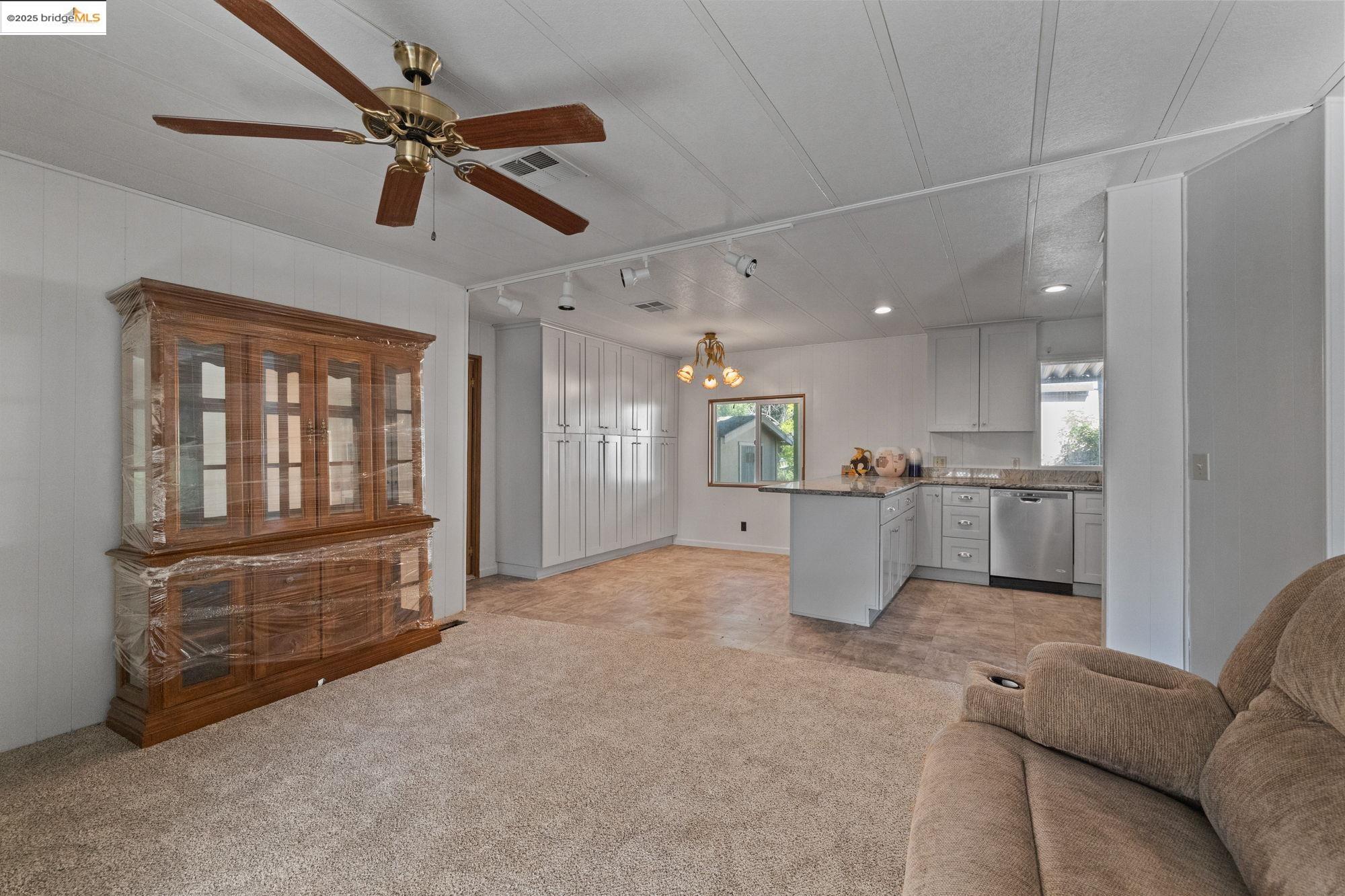 10956 Green Street, Unit 186 Columbia, CA 95310 - Photo 5 of 21 Living room with a chandelier, light carpet, and ceiling fan