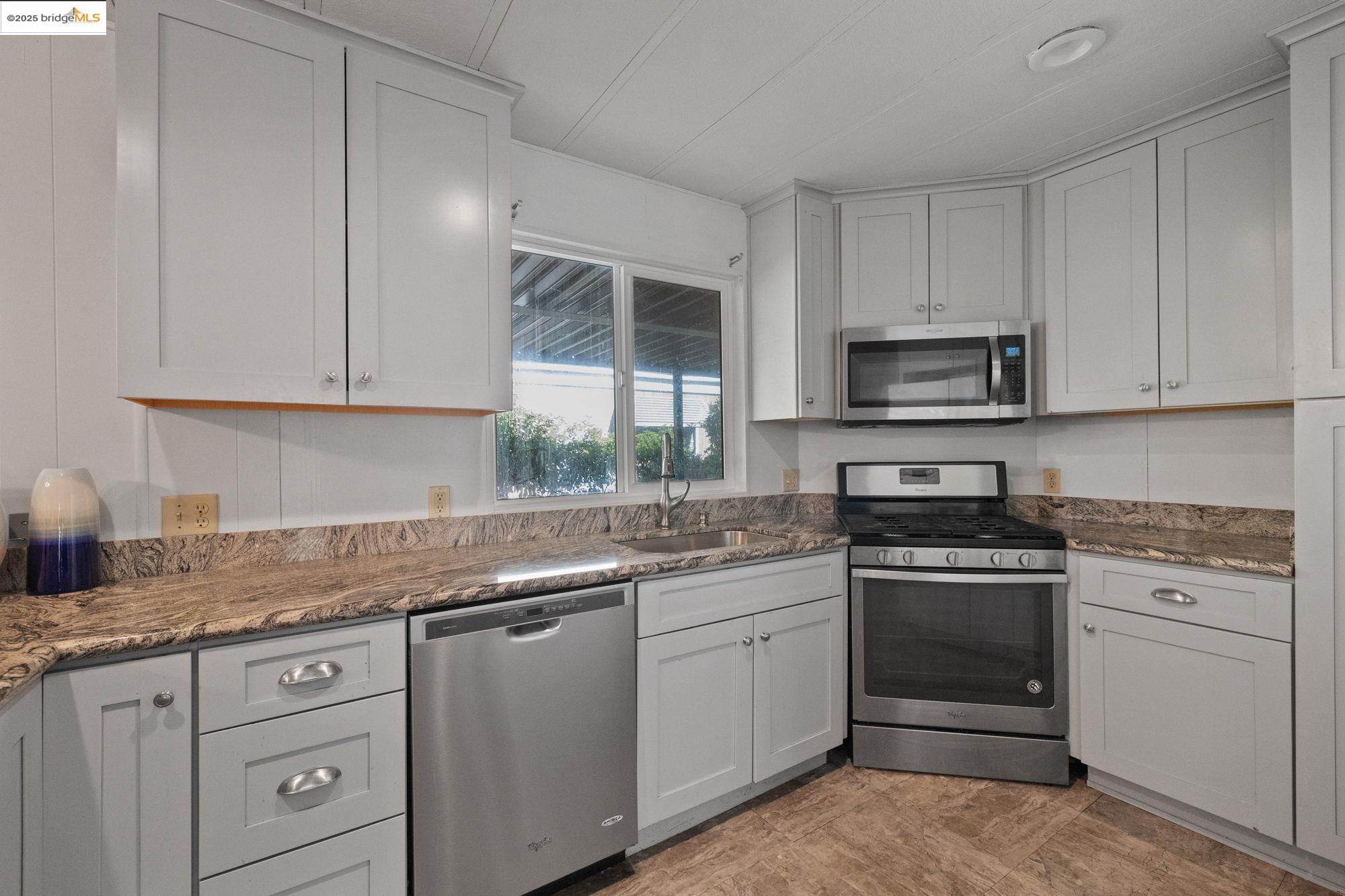 10956 Green Street, Unit 186 Columbia, CA 95310 - Photo 7 of 21 Kitchen featuring stainless steel appliances and dark stone countertops