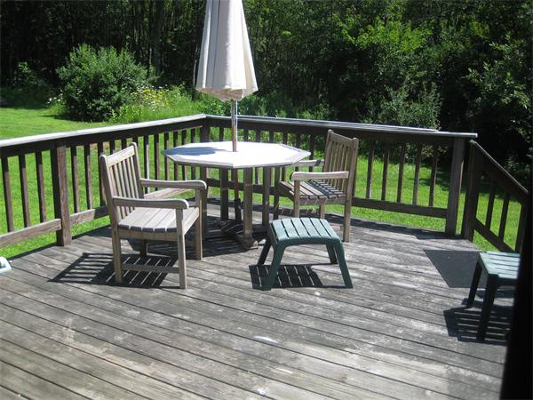 98 Adams Road Grafton, MA 01536 - Photo 12 of 15 a view of a chairs and table in the deck