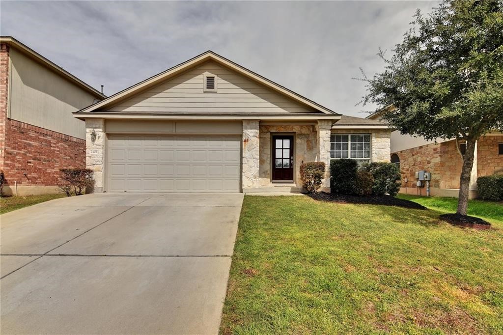 a front view of house with yard and green space